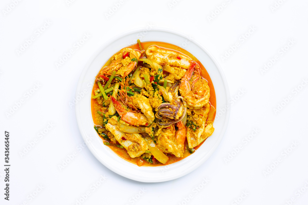 Fried seafood with curry powder on white