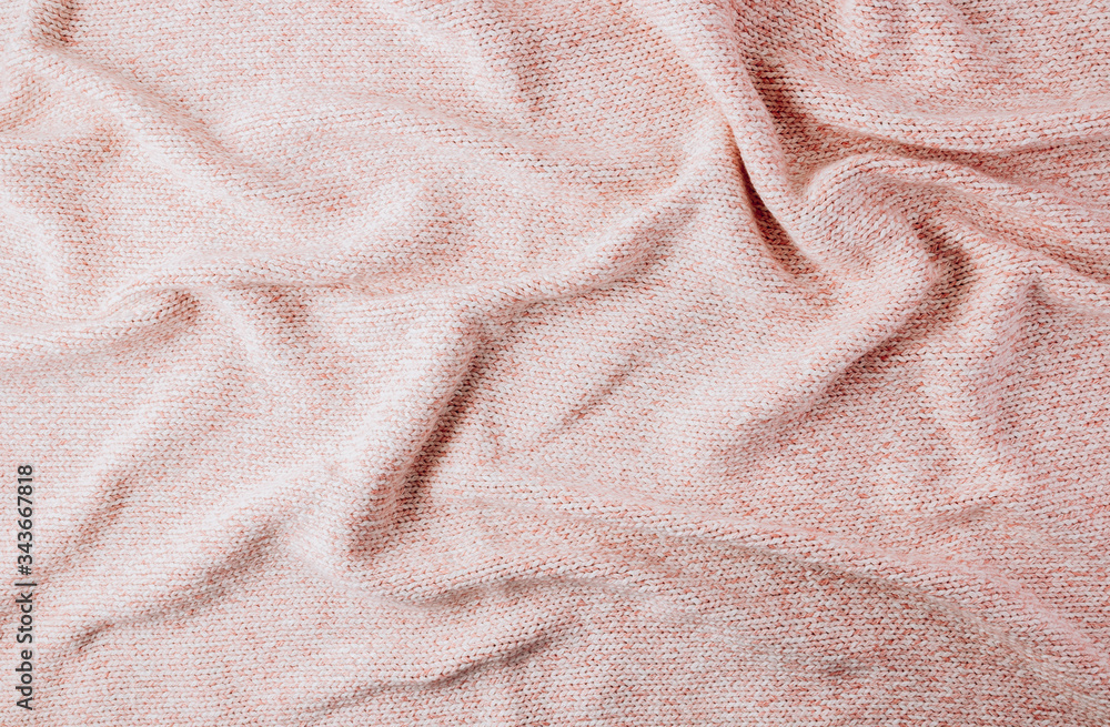Pink knited cotton plaid. Top view. Cozy sleep concept
