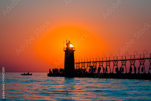 Sun perfectly framed in South Haven's lighthouse at sunset in Michigan