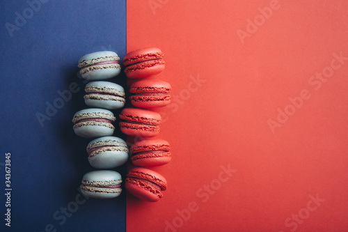 french strawberry red and blueberry blue macaroons on a colorful background
