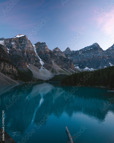 Beautiful Moraine Lake in Banff National Park during Dusk with Beautiful Landscape, Calm Waters and Reflection in the Water 