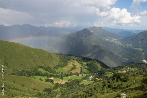 Fototapeta Naklejka Na Ścianę i Meble -  Picturesque landscape with rainbow over mountains in a sunny day.