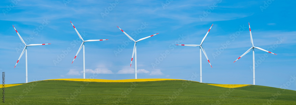 Wind turbines on green mountain grass. Panoramic clean energy concept Wind turbines on green mountain grass. Panoramic clean energy concept
