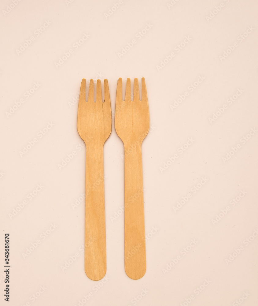 Wooden eating utensils isolated against white background