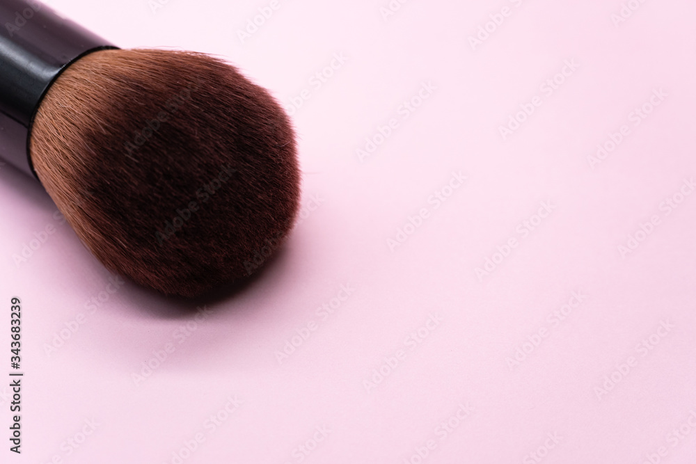Professional makeup brushes with silver handle on pink background with copy space. Concept for beauty and face cosmetic Professional makeup brushes with silver handle on pink background with copy space. Concept for beauty and face cosmetic