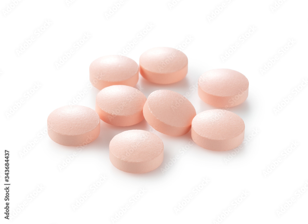 Pink pills placed on a white background Pink pills placed on a white background
