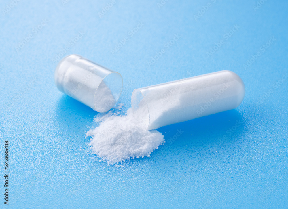 White capsules placed on blue background White capsules placed on blue background