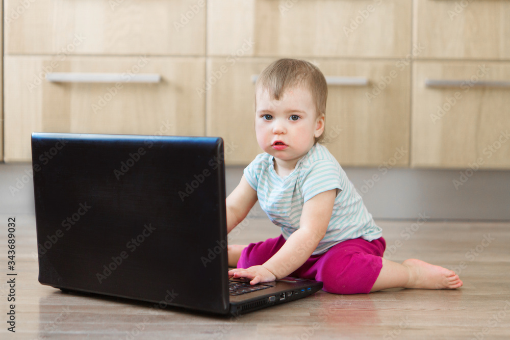 small child plays on computer. The child Prodigy learns the techniques of business Planning, home work, quarantine, self-isolation, protection from coronavirus, virus. Ordering products over Internet 