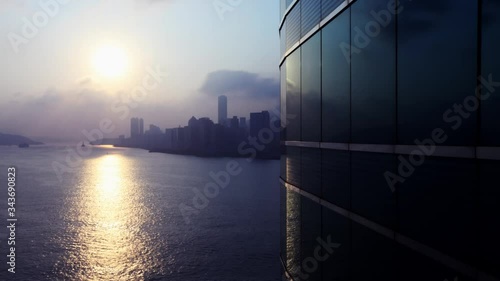 beautiful day timelapse of hongkong harbour from a business building with windows in front photo