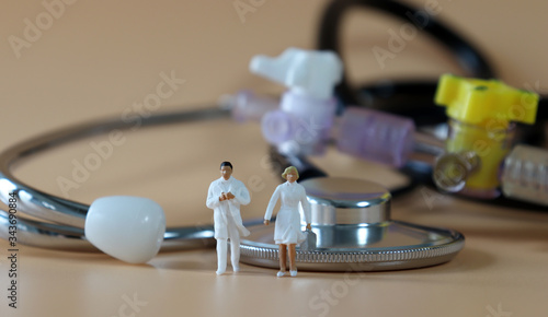 Stethoscope and Miniature doctor and nurse. 