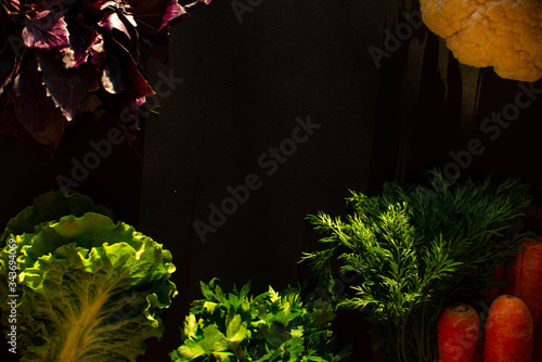 Fresh vegetables and cooking ingredients on a black background.