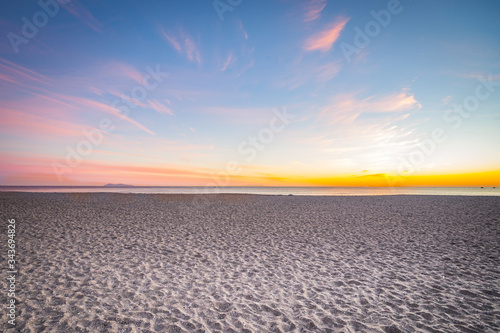 Idyllic perfect tropical white sandy beach and colorful sunset