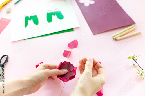 Instruction step 6. DIY greeting card as a gift for mom s day with an applique with a flower made of paper.
