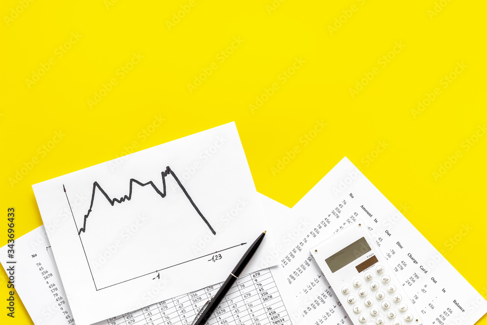 World financail crisis - arrow down, markets crash - on yellow office desk top view space for text World financail crisis - arrow down, markets crash - on yellow office desk top view space for text