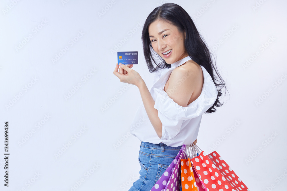 asian woman holding credit card and paper bags asian woman holding credit card and paper bags