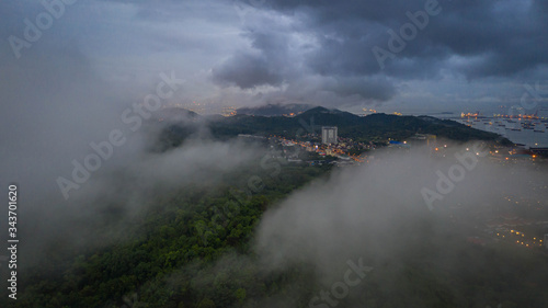 The high angle of the Asian business city in the fog and mountains that surround the city