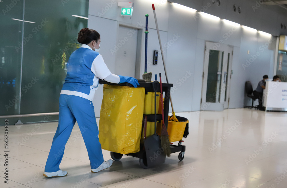 Closeup of janitorial, cleaning equipment and tools for floor cleaning and woman worker. Closeup of janitorial, cleaning equipment and tools for floor cleaning and woman worker.