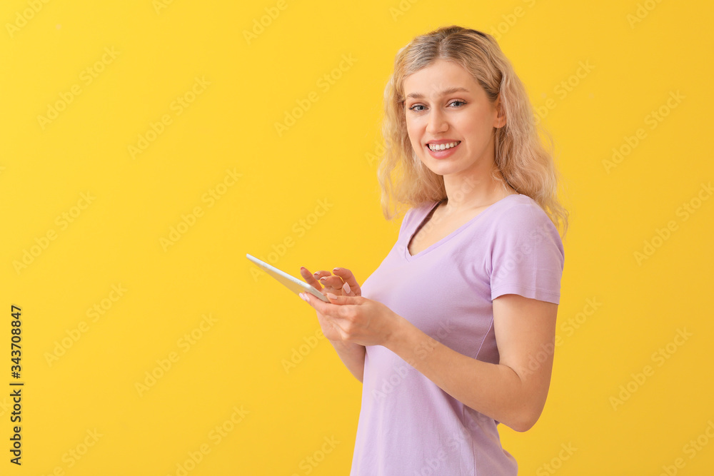 Young woman with tablet computer checking her e-mail on color background Young woman with tablet computer checking her e-mail on color background