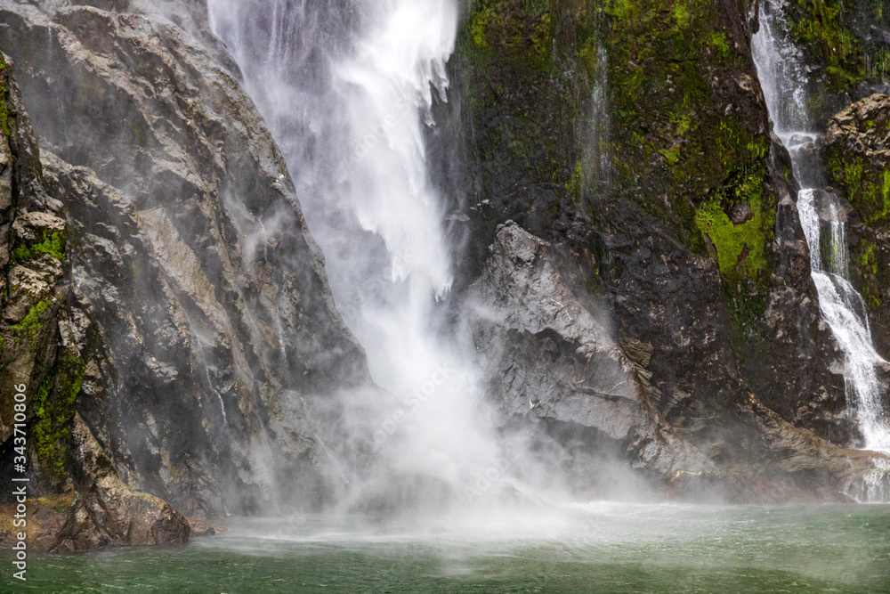 Waterfall at Milford sound in New Zealand. South Island. Waterfall at Milford sound in New Zealand. South Island.