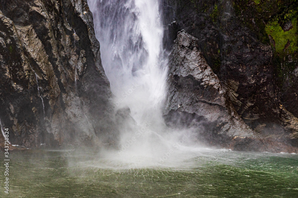 Waterfall at Milford sound in New Zealand. South Island. Waterfall at Milford sound in New Zealand. South Island.