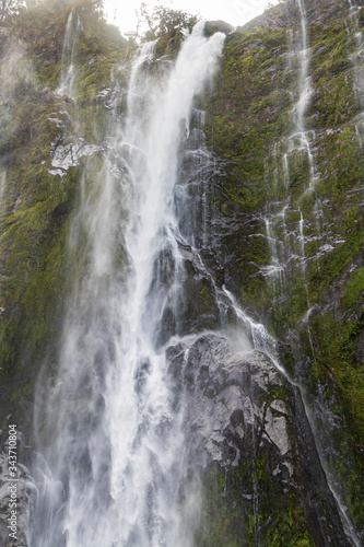 Waterfall at Milford sound  in New Zealand. South Island.