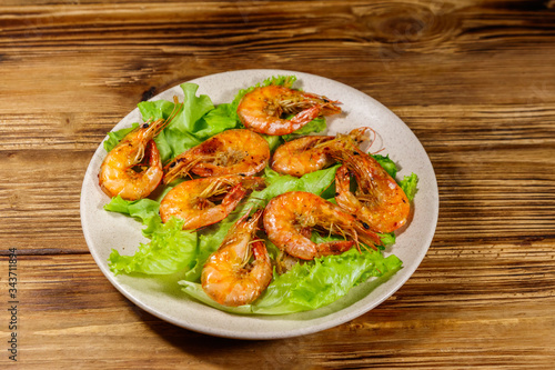 Tasty baked shrimps on a wooden table