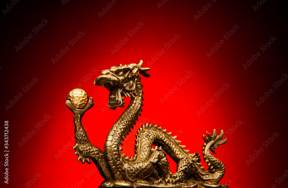 Chinese Dragon holding a gold Sphere and a red background Chinese Dragon holding a gold Sphere and a red background