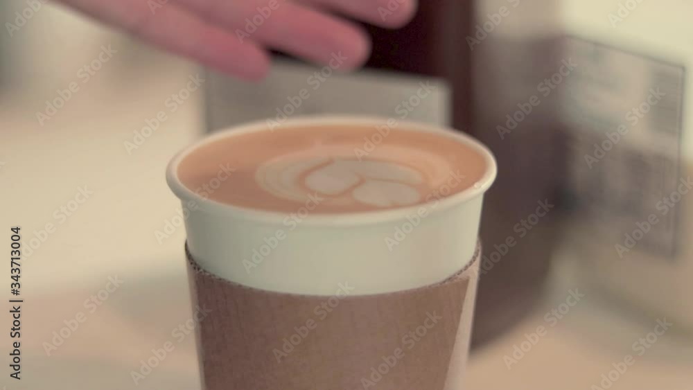 Finishing the perfect latte with a topping of cinnamon. Finishing the perfect latte with a topping of cinnamon.