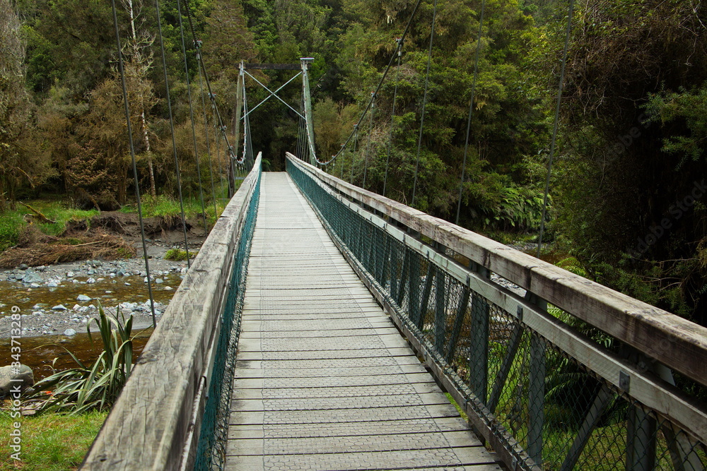 Suspension bridge on Lake Matheson Walk in West Coast on South Island of New Zealand
