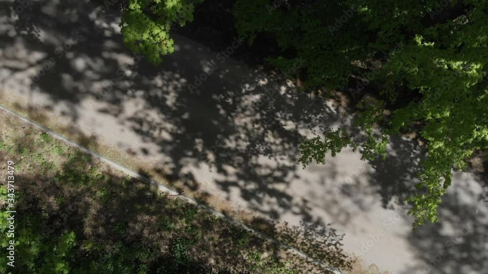 Shooting from aerial drone, a panoramic view from top for two cars that ride on a forest road. Shooting from aerial drone, a panoramic view from top for two cars that ride on a forest road.