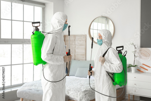 Workers in biohazard suits ...