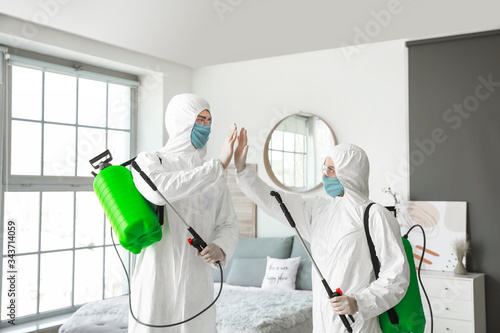 Workers in biohazard suits ...