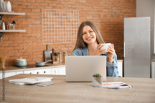 Young woman with laptop wor...