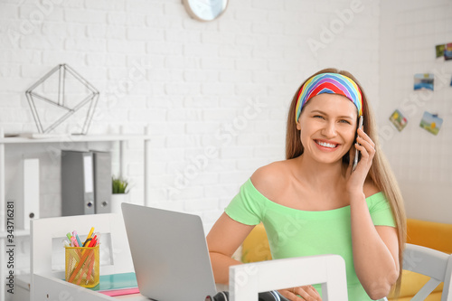 Young woman with laptop and...