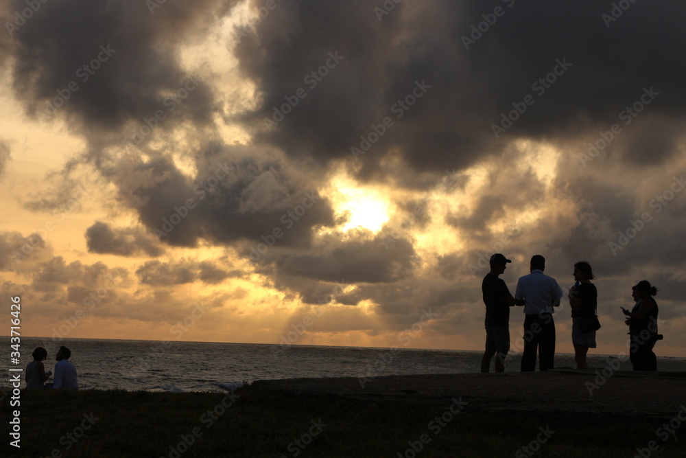 Old Dutch Fort Galle Sri Lanka - 06112018: a beautiful landscape of local tour guide explaining to two tourist about old dutch fort and a lovely couple enjoying the sun set at the sun set time
