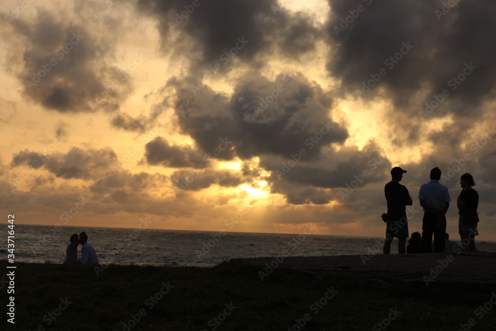Old Dutch Fort Galle Sri Lanka - 06112018: a beautiful landscape of local tour guide explaining to two tourist about old dutch fort and a lovely couple enjoying the sun set at the sun set time