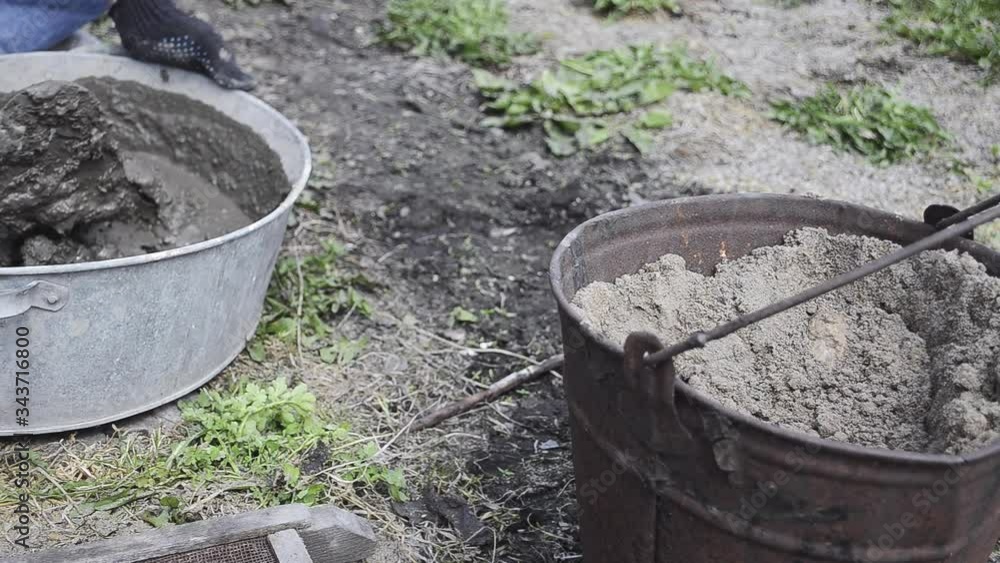 View of bucket of sand and cement bath View of bucket of sand and cement bath
