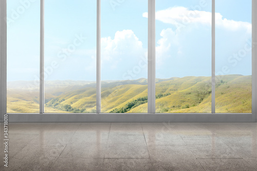 Empty room with green hills view