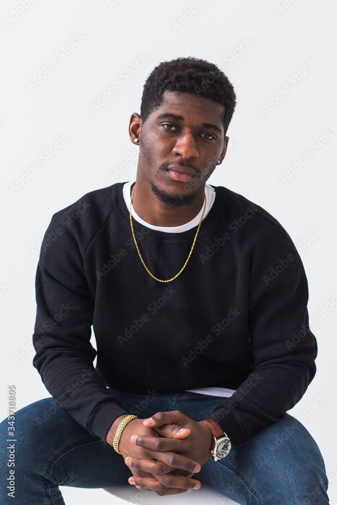 Handsome African American man posing in black sweatshirt on a