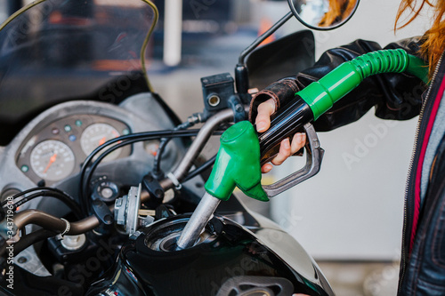 
detail of a person putting fuel in his vehicle, concept of refueling