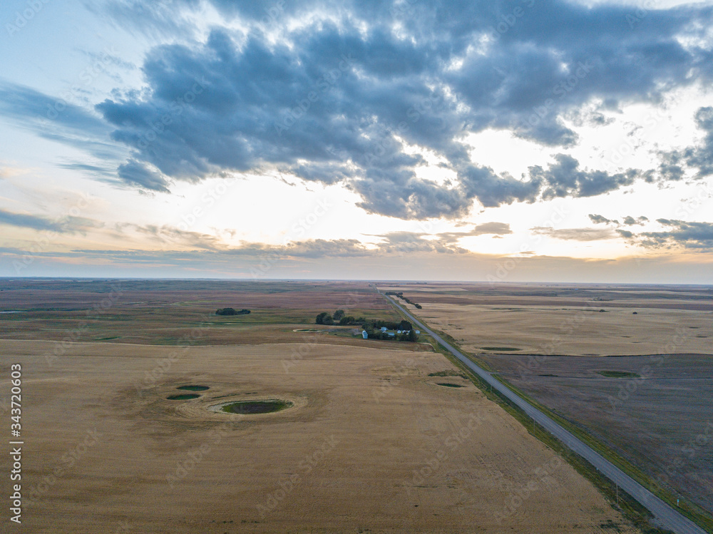 sunset aerial footage drone photography of road and fields in saskatchewan Canada Hazlet during sunset in summer fields after harvesting 
