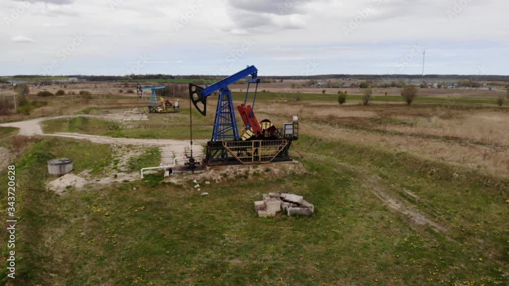 Oil Drilling Derricks Oilfield Aerial View For Fossil Fuels Output and Crude Oil Production From Ground. Aerial View Oil drill rig and pump jack, industrial equipment. Oil Drilling Derricks Oilfield Aerial View For Fossil Fuels Output and Crude Oil Production From Ground. Aerial View Oil drill rig and pump jack, industrial equipment.