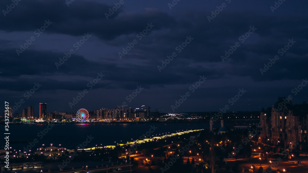 Russia. Kazan. August, 2019. Summer. View of the night coast of Kazan. Ferris wheel. City center