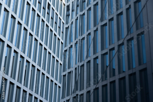 Facade of a Corporate Building mirroring in another facade, side by side