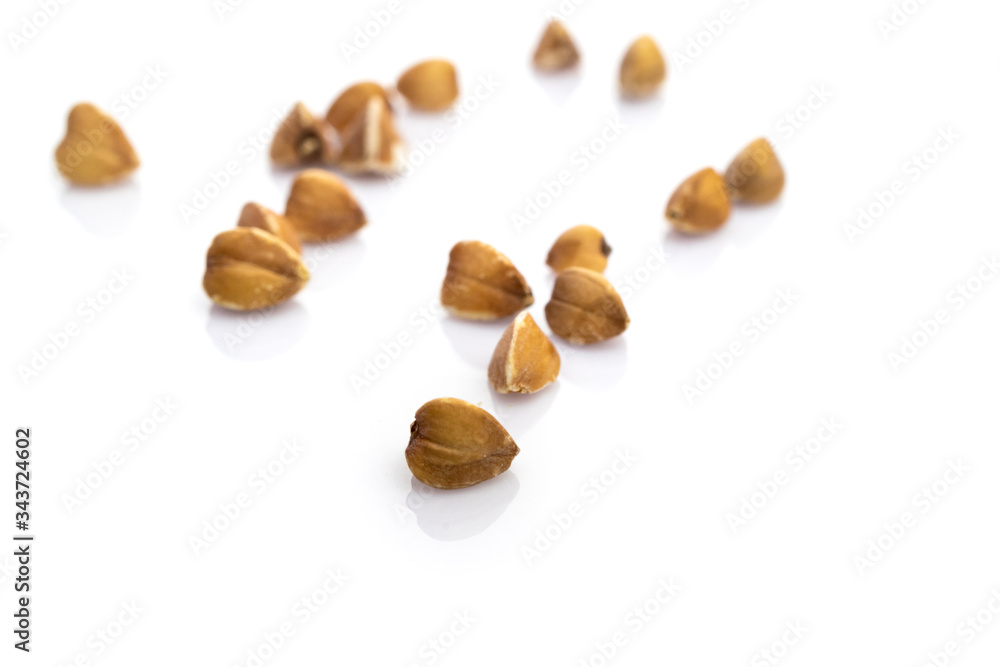 Buckwheat isolated on white. Brown organic vegetarian cereal seeds. Raw grains food. Vegan gluten-free organic, healthy diet superfood with antioxidant, omega-3, protein, mineral nutrients. Buckwheat isolated on white. Brown organic vegetarian cereal seeds. Raw grains food. Vegan gluten-free organic, healthy diet superfood with antioxidant, omega-3, protein, mineral nutrients.