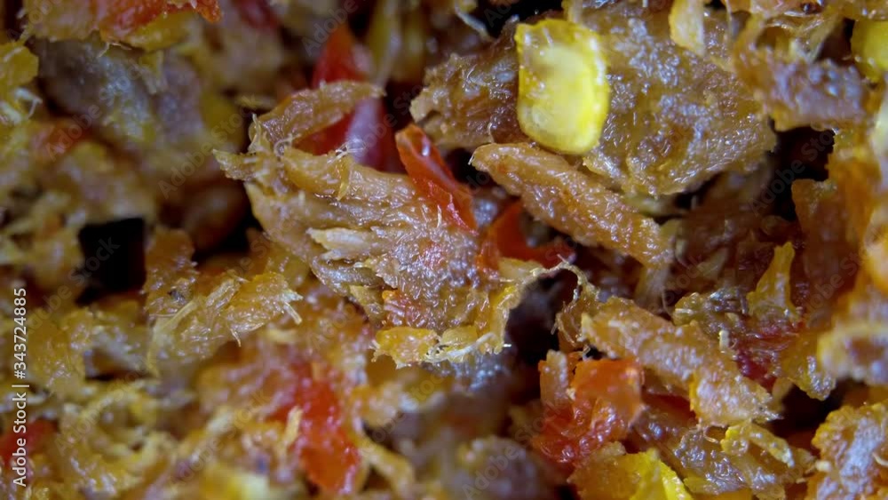 Fried extra spicy chili shredded tuna pieces. Macro close up shot of Asian delicacy street food. Fried extra spicy chili shredded tuna pieces. Macro close up shot of Asian delicacy street food.