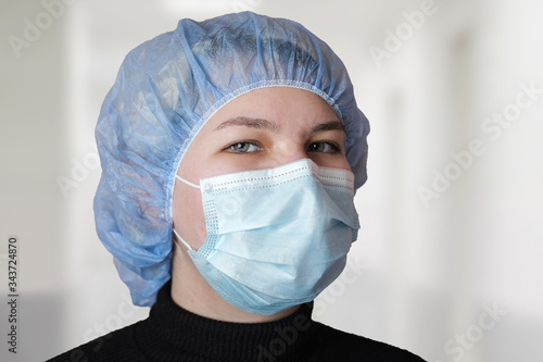 Close-up of the doctor's eyes. Medical employees in a protective mask and cap