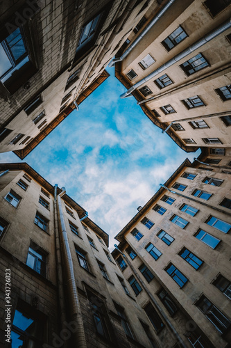 Yard well in Saint-Petersburg, square window to the sky from the buildings, the geometry of the architecture