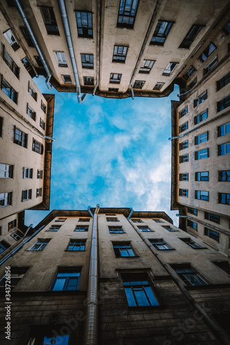 Yard well in Saint-Petersburg, square window to the sky from the buildings, the geometry of the architecture