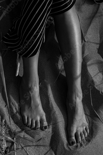female feet in the sand